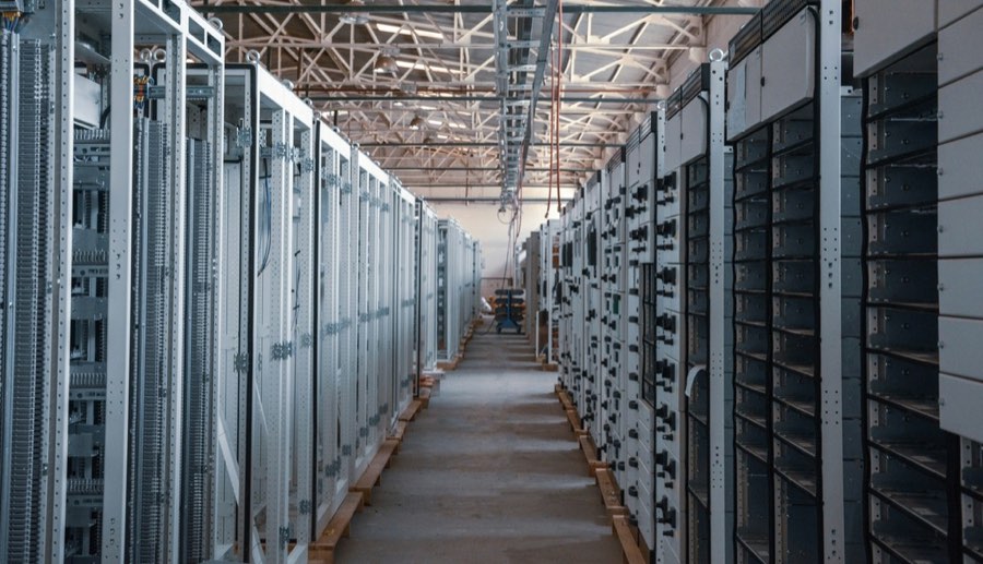 Rows of electrical switchgear cabinets inside a data-centre hall