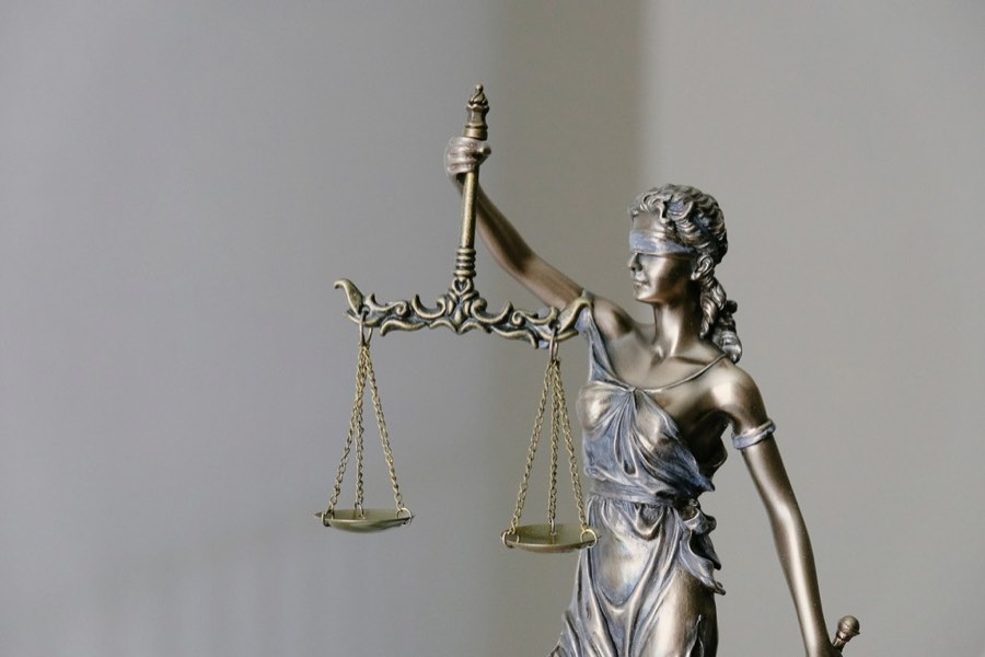 A statue of Justice holding balanced scales