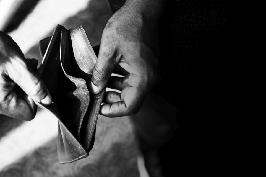 Hands holding an empty wallet, in black and white